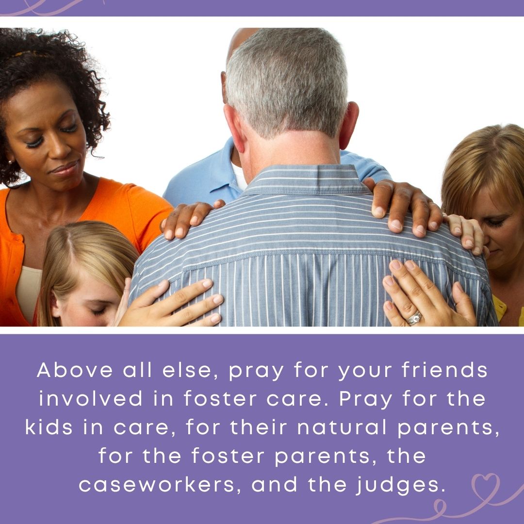 A diverse group of adults and a child gather closely around a man, placing their hands on his shoulders and bowing their heads in prayer together. Text overlay reads: "Above all else, pray for your friends involved in foster care. Pray for the kids in care, for their natural parents, for the foster parents, the caseworkers, and the judges."