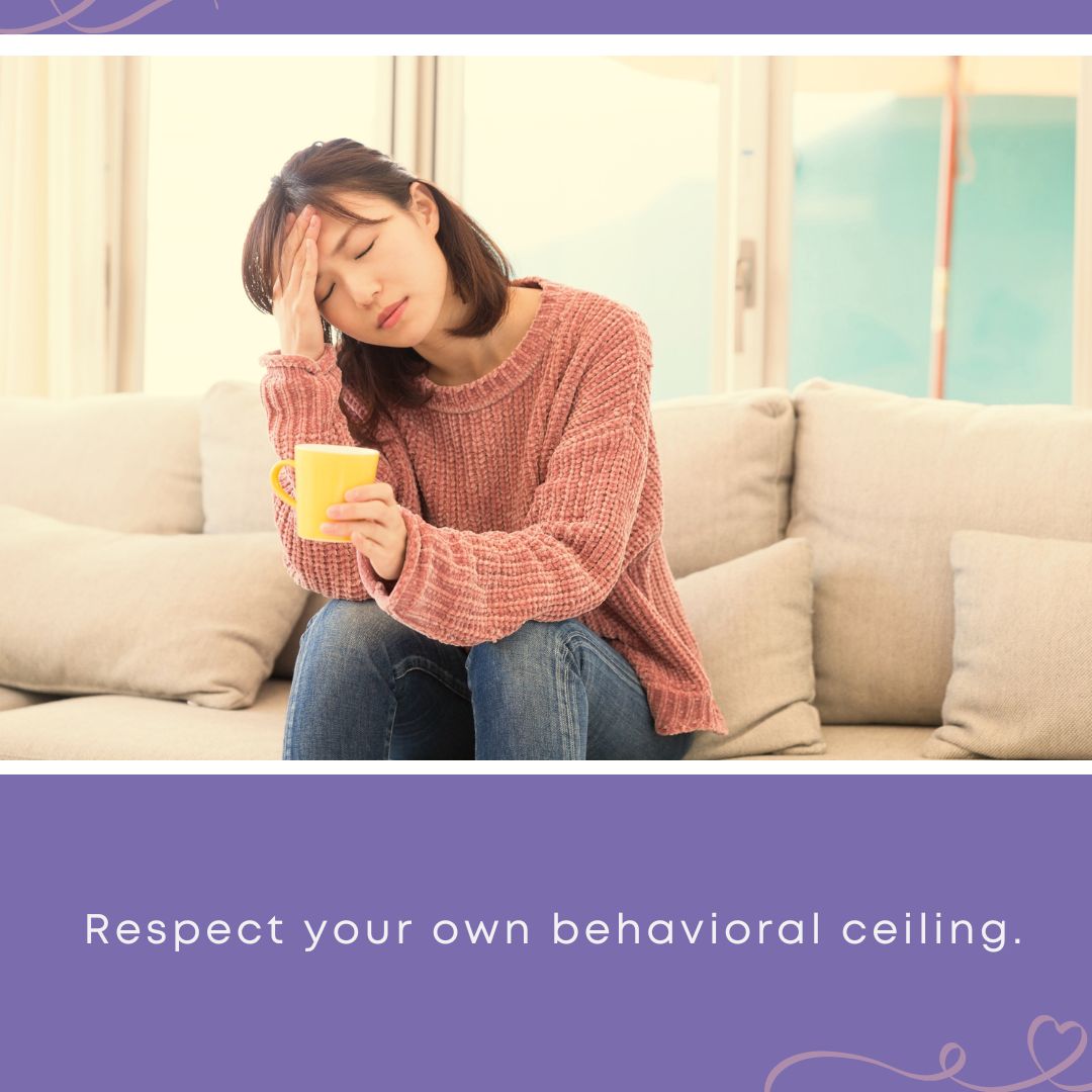 An exhausted woman resting her head in her hand while holding a mug, illustrating the summertime expectation-managing tip 'Respect your own behavioral ceiling.'