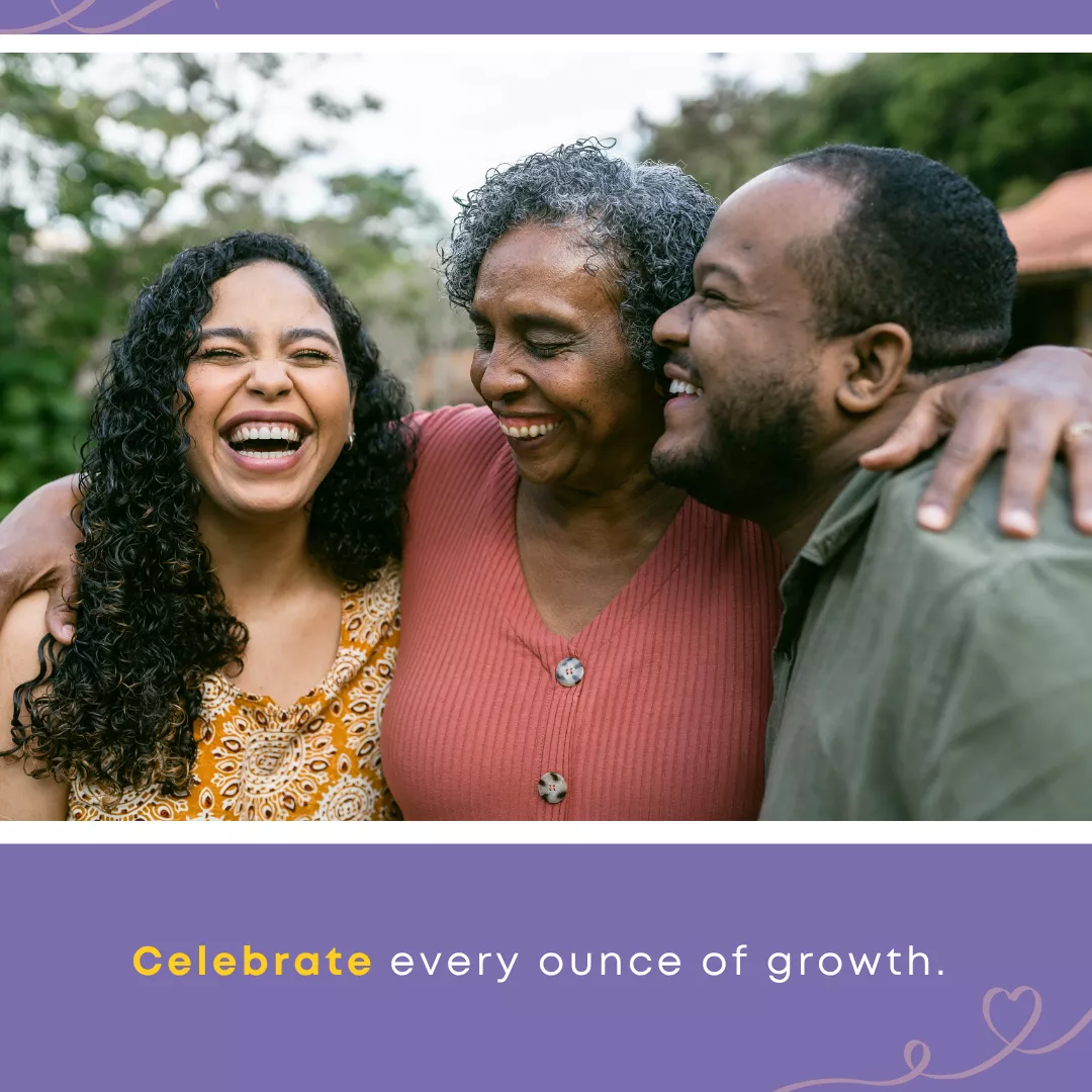 Three family members share a joyful embrace, celebrating growth and connection while parenting trauma-impacted adult children.