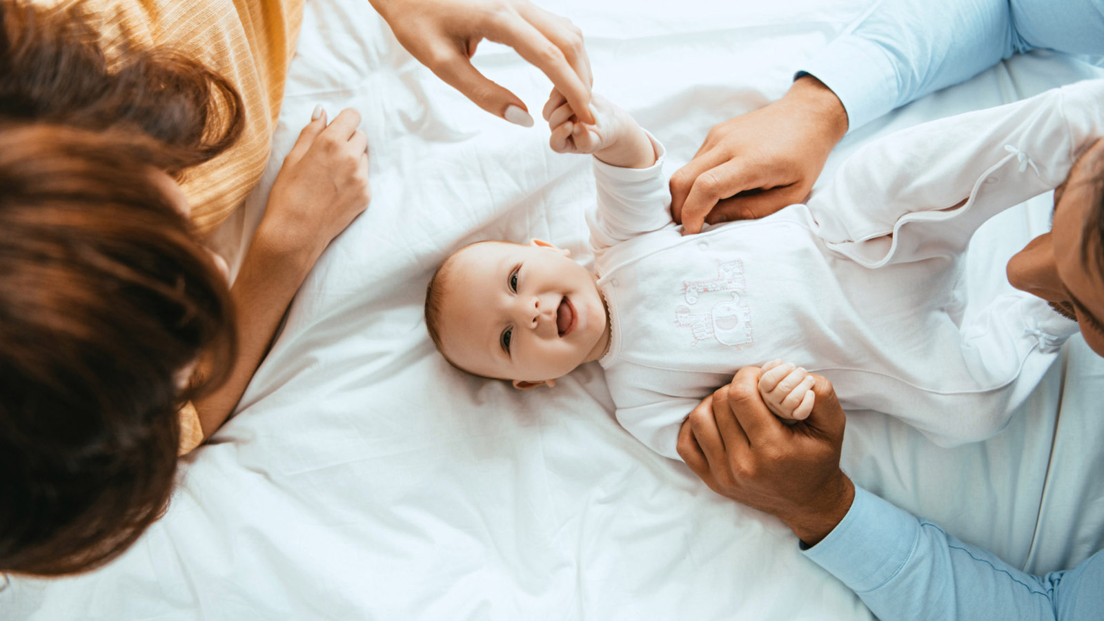A pair of foster parents spend time with their baby.
